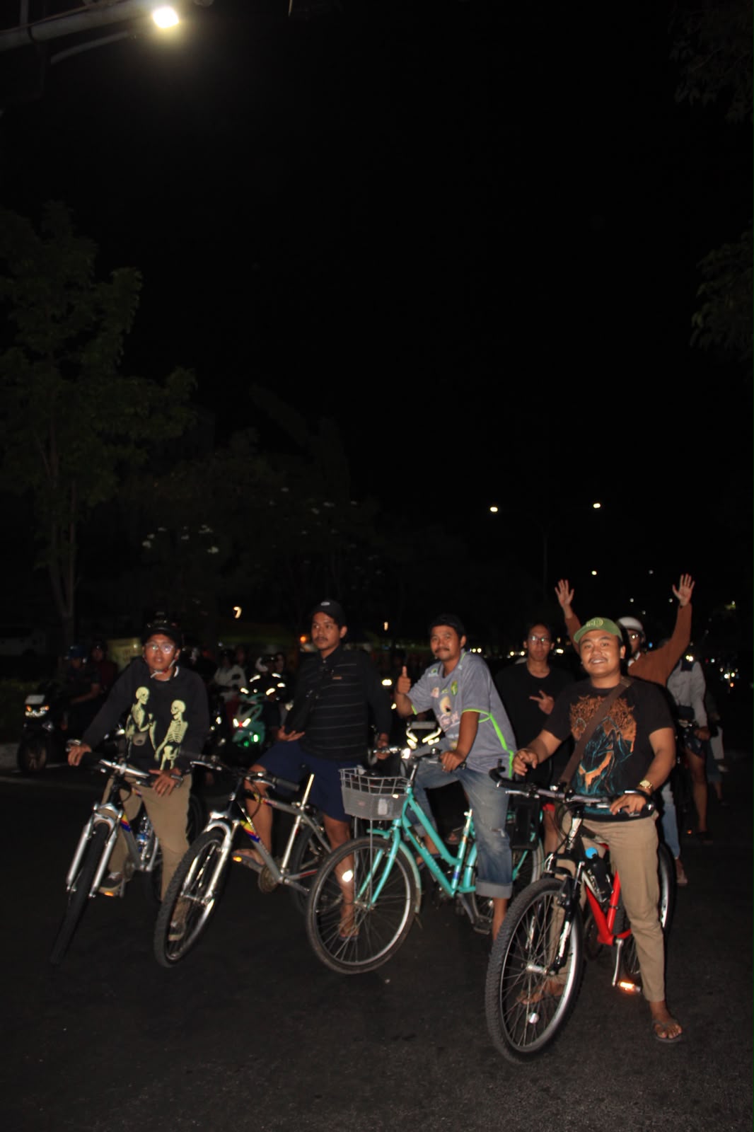 Group of riders on a city street at night